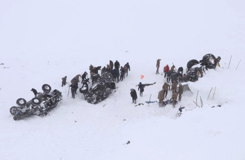 Turkish soldiers and locals try to rescue people trapped under an avalanche in Bahcesaray in Van province (photo credit: REUTERS)