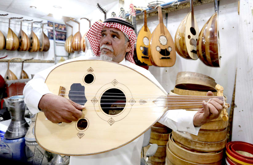 A Saudi plays the oud in a shop at the Hilla market, inRiyadh, Saudi Arabia (photo credit: AHMED YOSRI/ REUTERS)