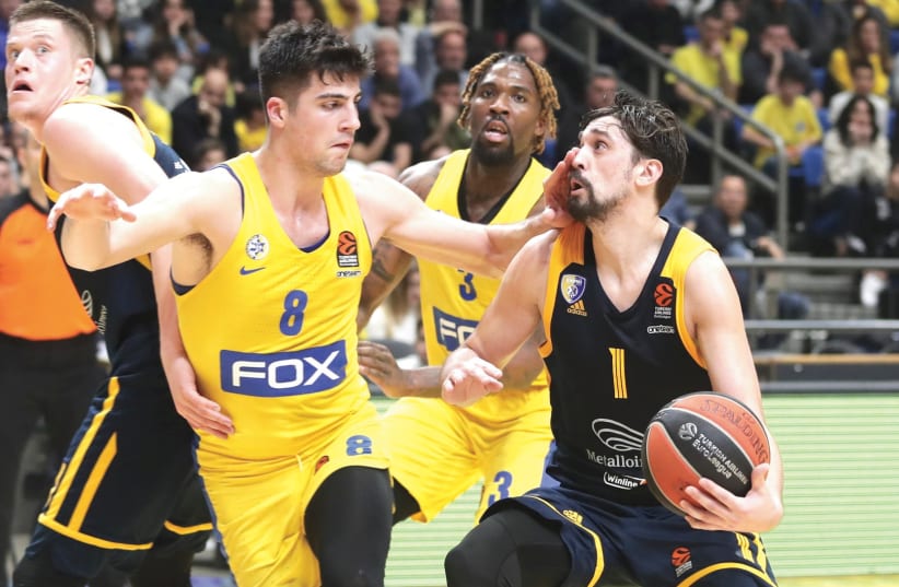 MACCABI TEL AVIV swingman Deni Avdija (8) helped neutralize Khimki Moscow guard Alexey Shved (1) on Wednesday night, while also contributing 11 points on the offensive end to help the yellow-and-blue notch a 80-77 Euroleague home victory. (photo credit: DANNY MARON)