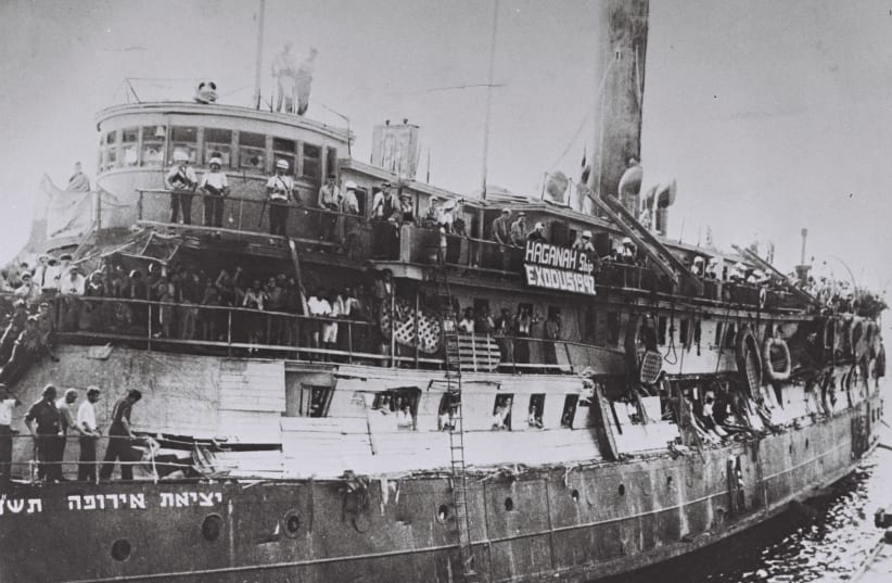 The 'EXODUS' ship following the Britsih takeover, with damage to its makeshift barriers. The banner reads, 'Haganah Ship Exodus 1947.' (photo credit: Wikimedia Commons)