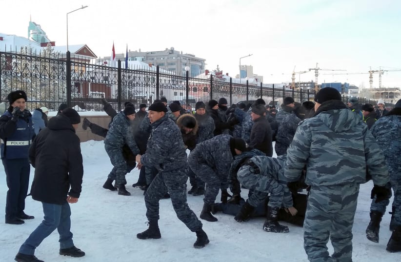 Police officers detain opposition supporters during a rally on Independence Day in Nur-Sultan, Kazakhstan December 16, 2019 (photo credit: REUTERS/TAMARA VAAL)