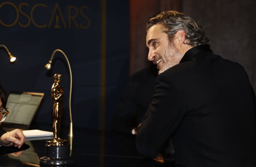 Best Actor Joaquin Phoenix waits for his Oscar statue to be engraved at the Governors Ball following the 92nd Academy Awards in Los Angeles, California, U.S., February 9, 2020 (photo credit: REUTERS/ERIC GAILLARD)