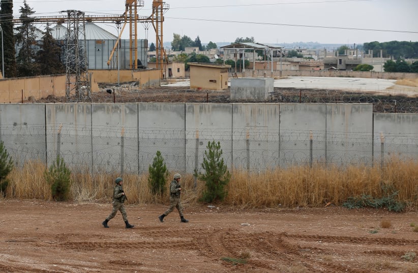 Turkish soldiers patrol along a wall on the border line between Turkey and Syria, in the Turkish border town of Ceylanpinar, in Sanliurfa province, Turkey, October 29, 2019 (photo credit: REUTERS/KEMAL ASLAN)