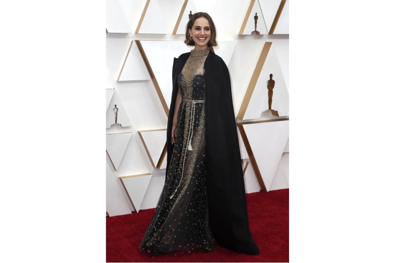 Natalie Portman wears a Dior cape embroidered with names of women directors who were not nominated for Oscars (photo credit: REUTERS/ERIC GAILLARD)
