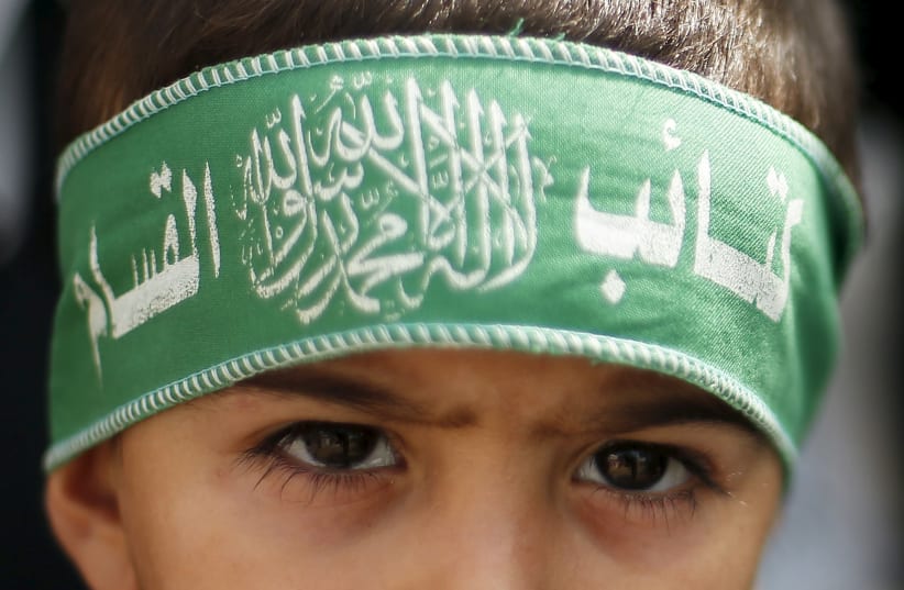 A Palestinian boy wears the headband of Hamas' armed wing as he takes part in a rally to protest against an Israeli police raid on Jerusalem's al-Aqsa mosque, in Gaza City September 15, 2015 (photo credit: REUTERS/SUHAIB SALEM)