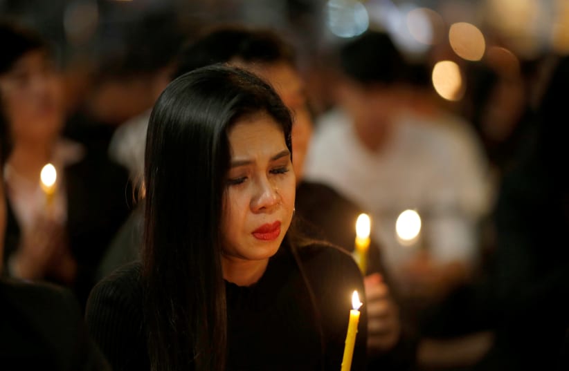 People pray for victims who died in a mass shooting at Terminal 21 shopping mall in Nakhon Ratchasima (photo credit: REUTERS)