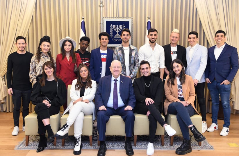 President Reuven Rivlln at the center of this photograph with Pop star Noa Kirel on his right side. Other teen-celebs include singer Agam Buhbut, second to his left, and actor Tal Mousseri known for his productions for children on the second row with the blue jacket (photo credit: AMOS BEN-GERSHOM/GPO)
