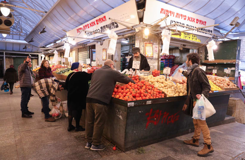 People are seen shopping for produce at the Mahaneh Yehuda shuk in Jerusalem. (photo credit: MARC ISRAEL SELLEM/THE JERUSALEM POST)