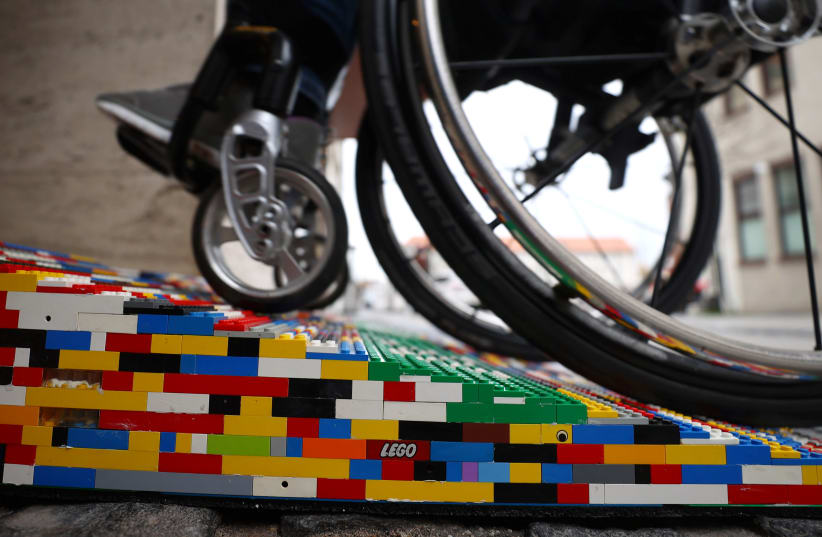 Rita Ebel, nicknamed "Lego grandma", tests one of her wheelchair ramps built from donated Lego bricks in Hanau (photo credit: REUTERS)