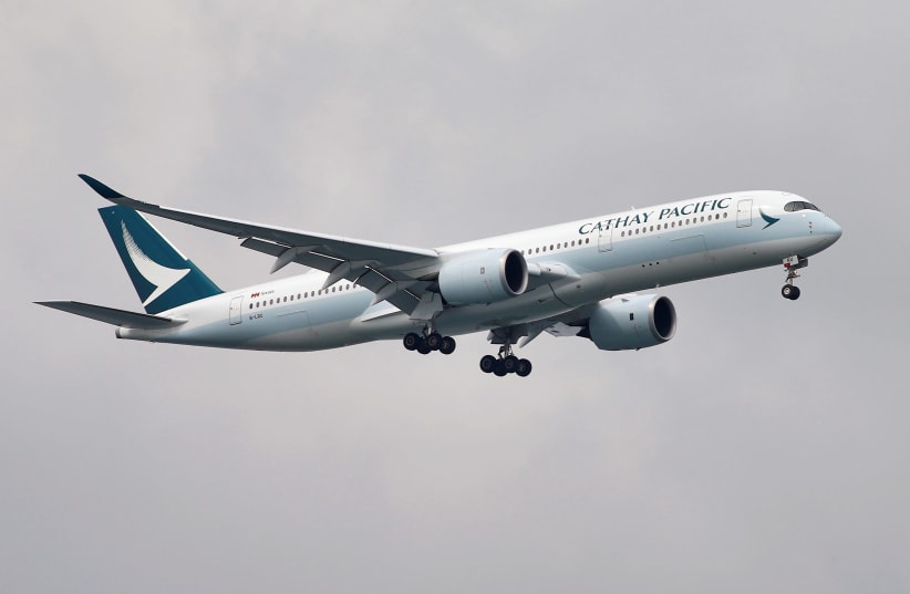 A Cathay Pacific Airways Airbus A350-900 airplane approaches to land at Changi International Airport in Singapore June 10, 2018. (photo credit: REUTERS/TIM CHONG)
