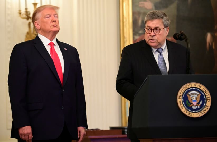 U.S. President Donald Trump and Attorney General William Barr participate in a presentation ceremony of the Medal of Valor and heroic commendations to civilians and police officers who responded to mass shootingsin Dayton, Ohio and El Paso, Texas during a ceremony in the East Room of the White House (photo credit: ERIN SCOTT/REUTERS)