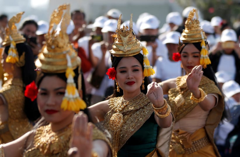 Apsara dancers perform as people watching at the Freedom Park during a celebration of the International Human Rights Day in Phnom Penh, Cambodia December 10, 2019 (photo credit: REUTERS/SAMRANG PRING)