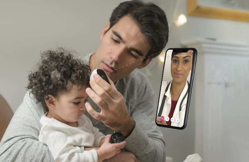 Father using Tyto Care device to take daughter's temperature. (photo credit: TYTO CARE.)