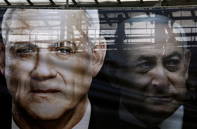 A banner depicts Benny Gantz, leader of Blue and White party, and Israel Prime minister Benjamin Netanyahu, as part of Blue and White party's campaign ahead of the upcoming election, in Tel Aviv, Israel February 17, 2020 (photo credit: AMMAR AWAD / REUTERS)