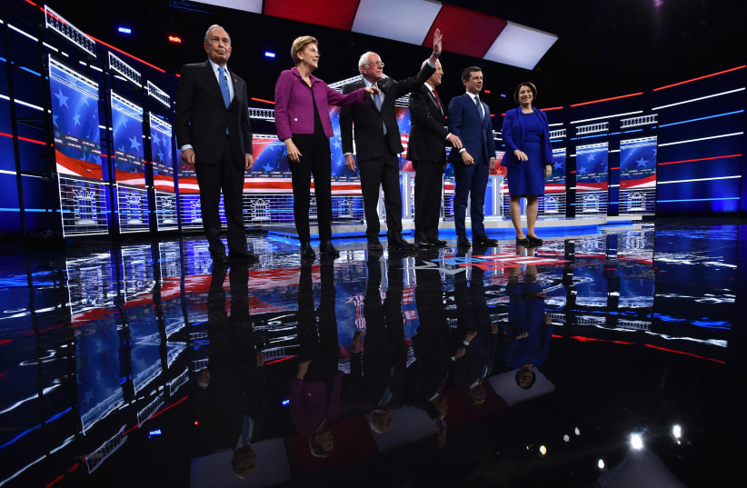 Candidates gather onstage for the ninth Democratic 2020 U.S. presidential debate at the Paris Theater in Las Vegas, Nevada, U.S. (photo credit: REUTERS/DAVID BECKER)