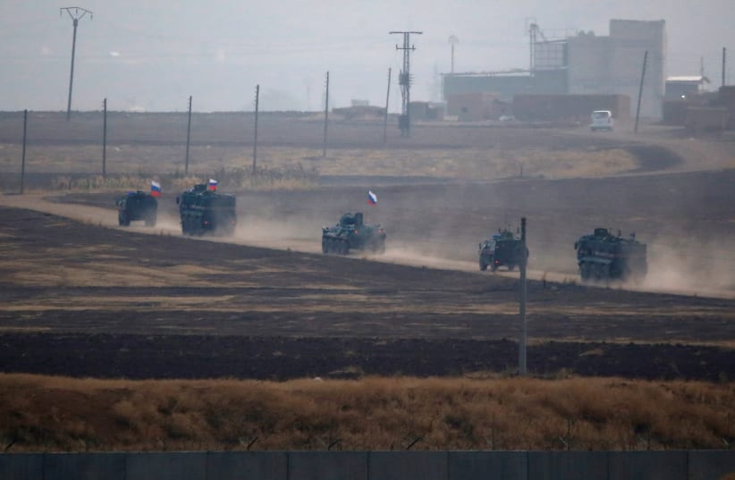 Russian military vehicles return following a joint Turkish-Russian patrol in northeast Syria (photo credit: REUTERS/KEMAL ASLAN)