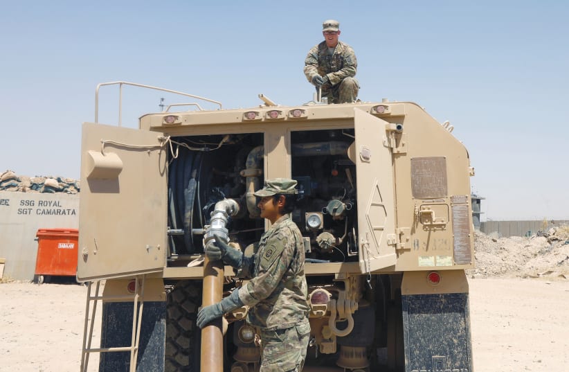 US SOLDIERS work a fuel truck at Q-West base in Iraq. (photo credit: REUTERS)