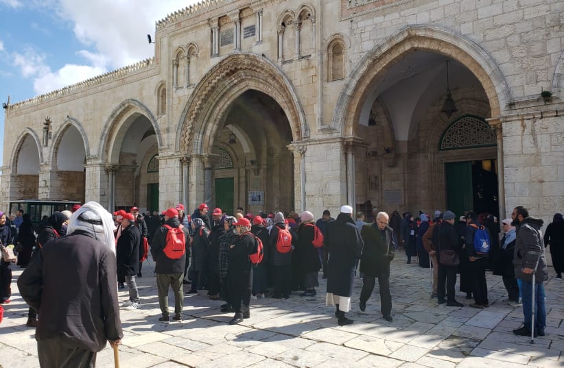 Pilgrims and tourists outside Al-Aqsa Mosque after the second prayer of the day (photo credit: SHAKIR RIMZY)
