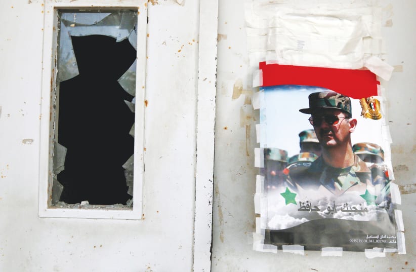 A POSTER of Syrian regime leader Bashar Assad in Latakia.  (photo credit: REUTERS)