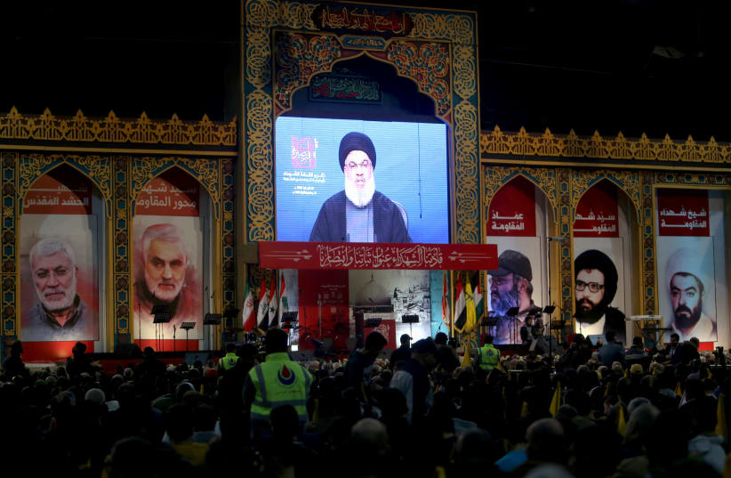 Lebanon's Hezbollah leader Sayyed Hassan Nasrallah addresses his supporters through a screen during a rally commemorating the annual Hezbollah's slain leaders in Beirut's southern suburbs, Lebanon February 16, 2020. (photo credit: AZIZ TAHER/REUTERS)