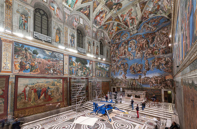 A tapestry designed by Renaissance artist Raphael is installed on a lower wall of the Sistine Chapel at the Vatican as part of celebrations marking the 500th anniversary of his death (photo credit: REUTERS)