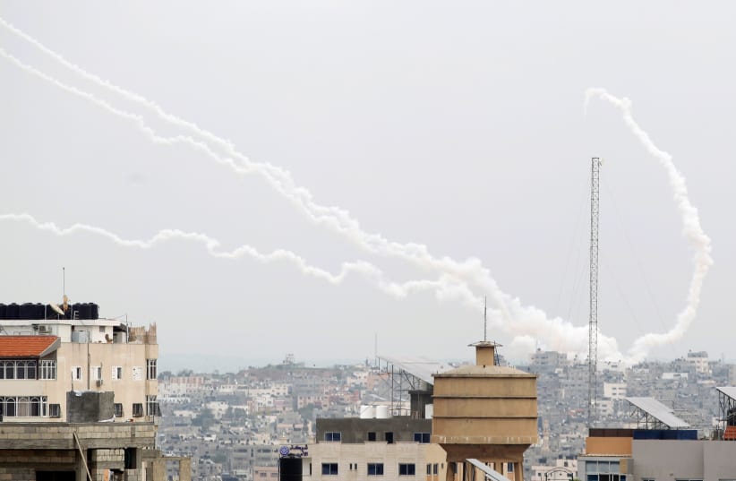 Trails of smoke are seen as rockets are fired towards Israel, in Gaza (photo credit: REUTERS)