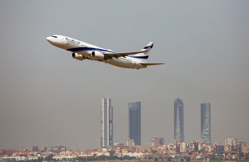 An El Al Israel Airlines Boeing 737-900ER airplane takes off from the Adolfo Suarez Madrid-Barajas airport as seen from Paracuellos del Jarama, outside Madrid, Spain, August 8, 2018 (photo credit: REUTERS/PAUL HANNA)