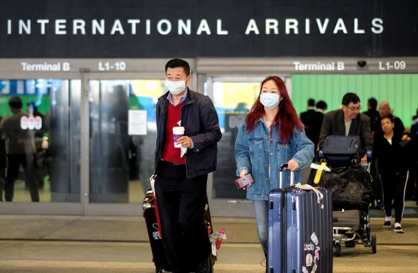 Passengers leave LAX after arriving from Shanghai, China, after a positive case of the coronavirus was announced in the Orange County suburb of Los Angeles, California, U.S., January 26, 2020 (photo credit: REUTERS/RINGO CHIU)