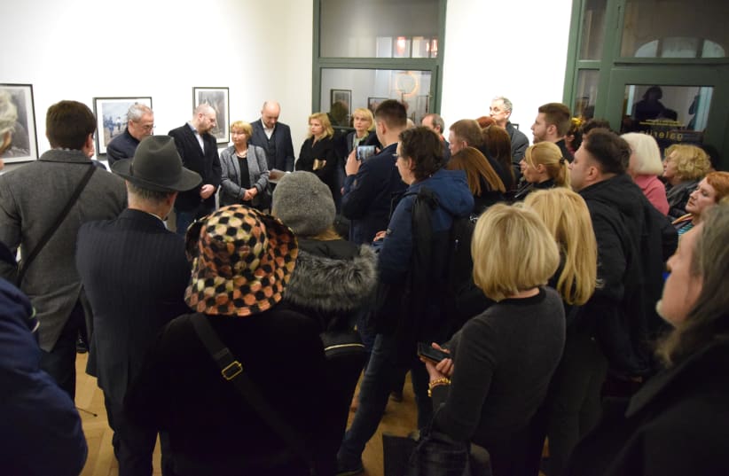 Guests view the exhibition of Meer Axelrod's 'Nazi Occupation' series in Zagreb, Croatia. (photo credit: MAYA LASKOVICH)