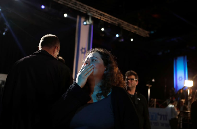 A supporter reacts as results of the exit polls are shown at Benny Gantz's Blue and White party headquarters, following Israel's national election, in Tel Aviv, Israel March 2 (photo credit: REUTERS/Ronen Zvulun)
