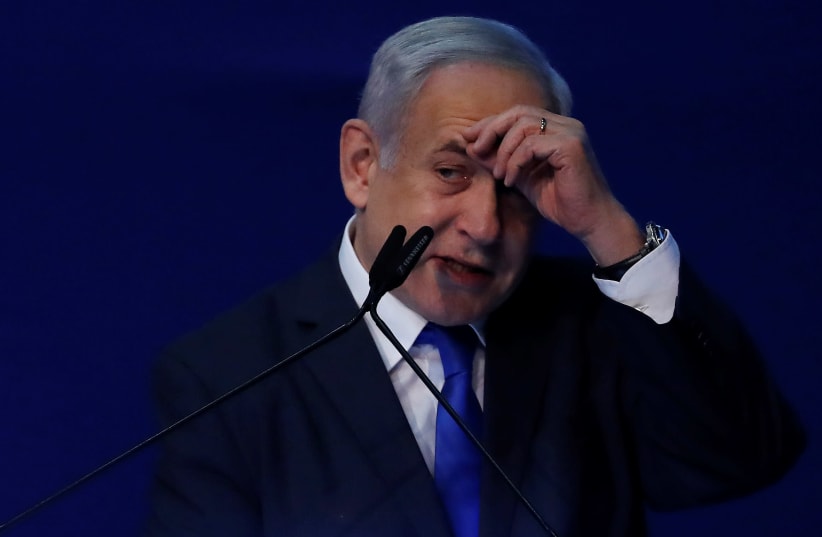 Israeli Prime Minister Benjamin Netanyahu gestures as he speaks to supporters following the announcement of exit polls in Israel's election at his Likud party headquarters in Tel Aviv, Israel March 3, 2020 (photo credit: REUTERS/AMMAR AWAD)