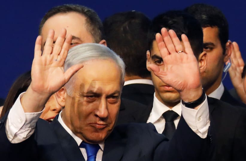 Israeli Prime Minister Benjamin Netanyahu gestures after speaking to supporters following the announcement of exit polls in Israel's election at his Likud party headquarters in Tel Aviv, Israel March 3, 2020 (photo credit: REUTERS/AMIR COHEN)