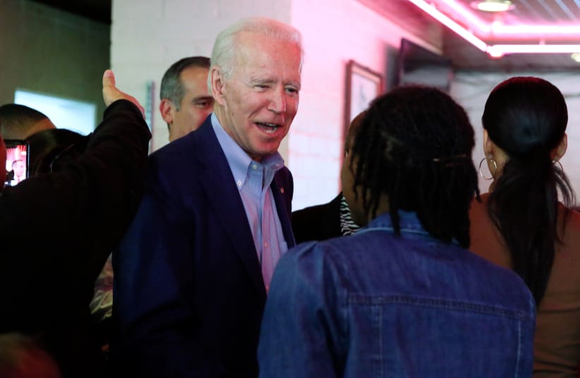 US Democratic presidential candidate and former Vice President Biden talks with customers as he campaigns before his evening rally on Super Tuesday in Los Angeles (photo credit: REUTERS)