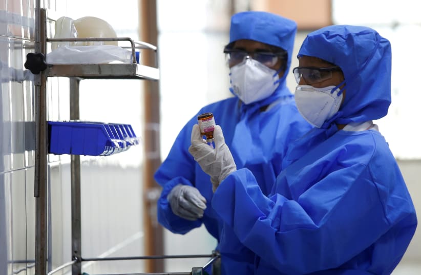 Medical staff with protective clothing are seen inside a ward specialised in receiving any person who may have been infected with coronavirus, at the Rajiv Ghandhi Government General hospital in Chennai (photo credit: REUTERS)