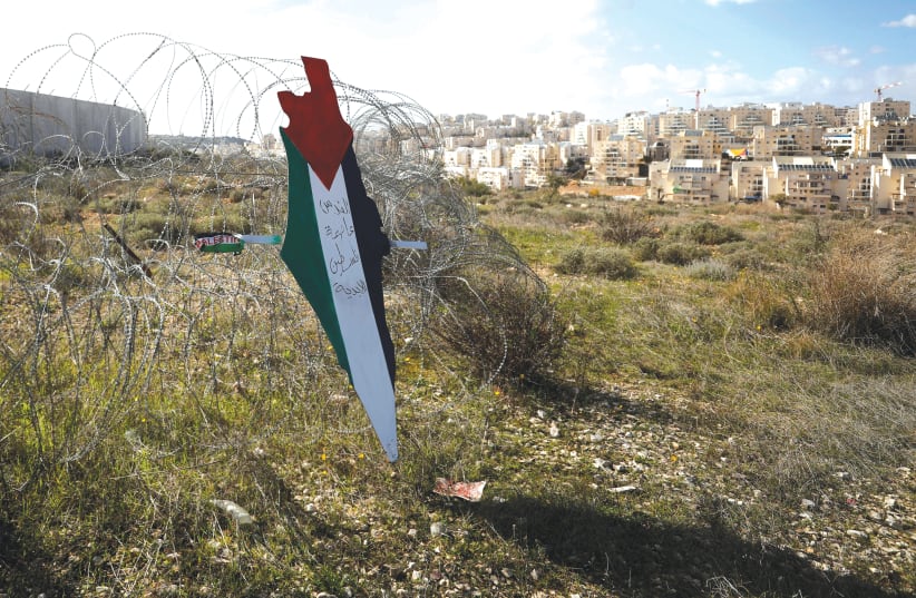A map with the colors of the Palestinian flag reading 'Jerusalem is the eternal capital of Palestine' near Bilin.  (photo credit: MOHAMAD TOROKMAN/REUTERS)