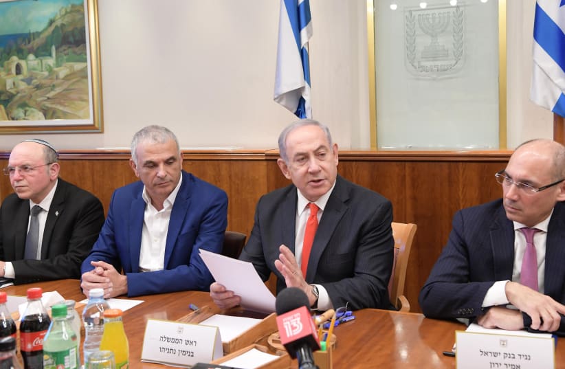 Prime Minister Benjamin Netanyahu discusses the impact of coronavirus with representatives from the Finance Ministry, March 5, 2020 (photo credit: AMOS BEN-GERSHOM/GPO)