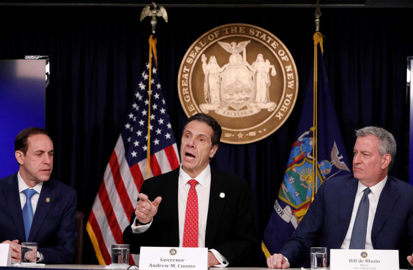Commissioner of Health for New York State Howard Zucker, New York Governor Andrew Cuomo and New York City Mayor Bill de Blasio deliver remarks at a news conference. New York, U.S., March 2, 2020. (photo credit: ANDREW KELLY / REUTERS)