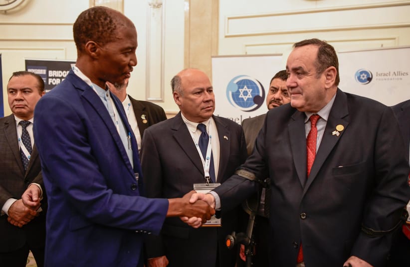 Bishop Scott Mwanza shakes hands with Guatemala’s president-elect Alejandro Giammattei at a recent Israel Allies Foundation event (photo credit: Courtesy)