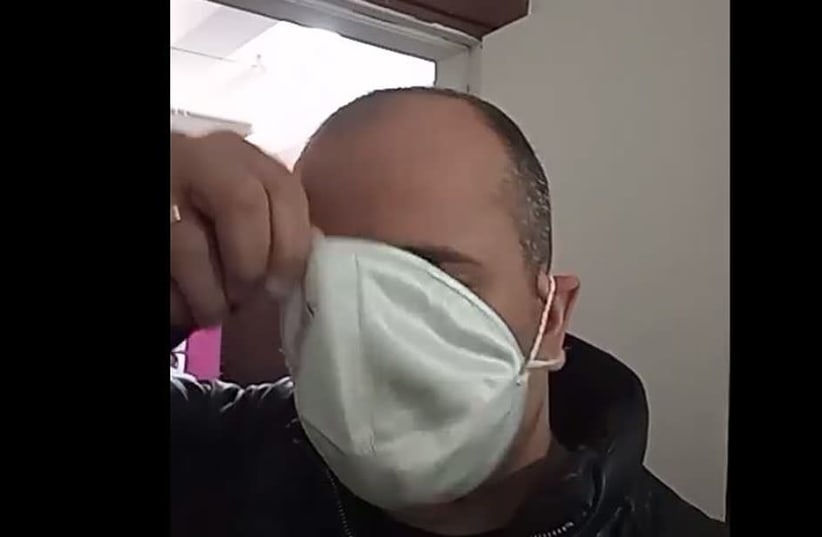 A French-speaking man pulls a kippah that he wore as a face mask back on his head (photo credit: SCREENSHOT FROM FACEBOOK VIA JTA)