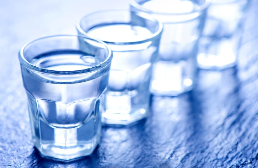 Vodka in small glasses and on a table (illustrative) (photo credit: INGIMAGE)