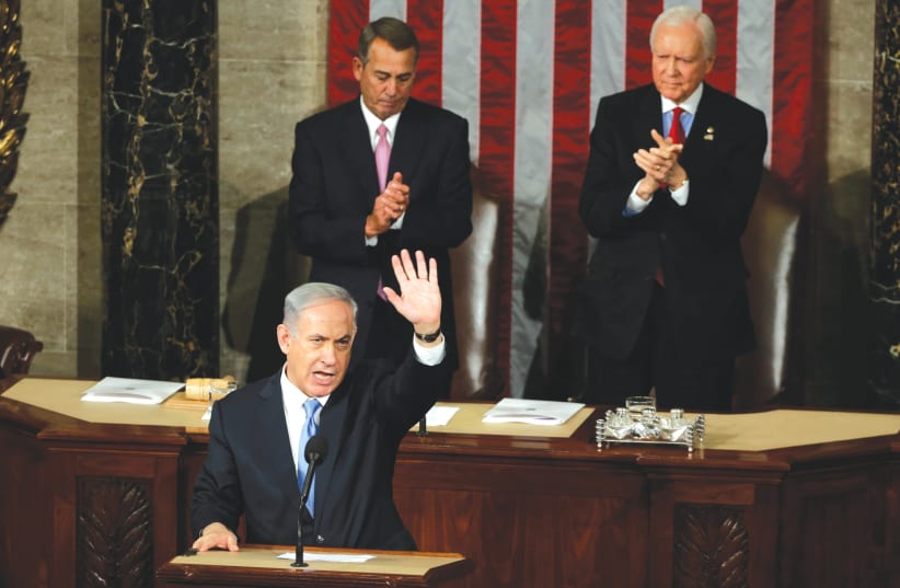 PRIME MINISTER Benjamin Netanyahu acknowledges applause at the end of his speech to a joint session of Congress in Washington on March 3, 2015. (photo credit: REUTERS/GARY CAMERON)