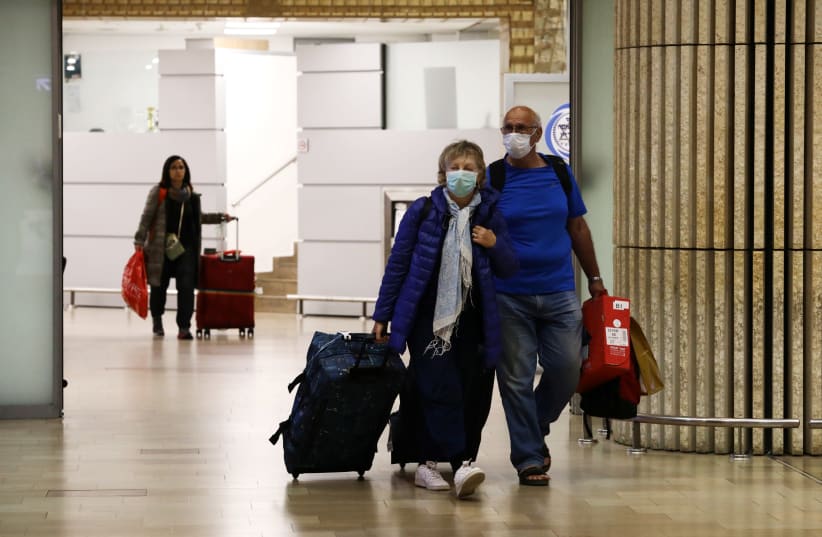 Passengers walk at the arrival area of a terminal at the Ben Gurion airport in Lod (photo credit: AMMAR AWAD/REUTERS)