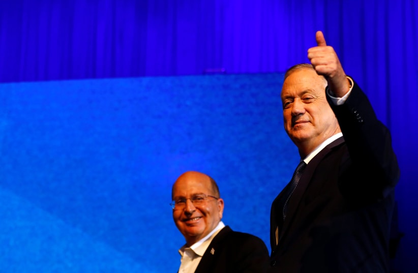 Blue and White party leader Benny Gantz gestures as he stands next to his party co-leader Moshe Yaalon after speaking to supporters following the announcement of exit polls in Israel's election at the party's headquarters in Tel Aviv, Israel March 3, 2020 (photo credit: REUTERS/CORINNA KERN)