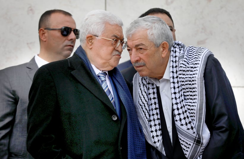 ABBAS CONFERS with senior Fatah official Mahmoud Aloul (right) during a ceremony marking the anniversary of the death of late PLO leader Yasser Arafat, in Ramallah on November 11, 2018. (photo credit: REUTERS)