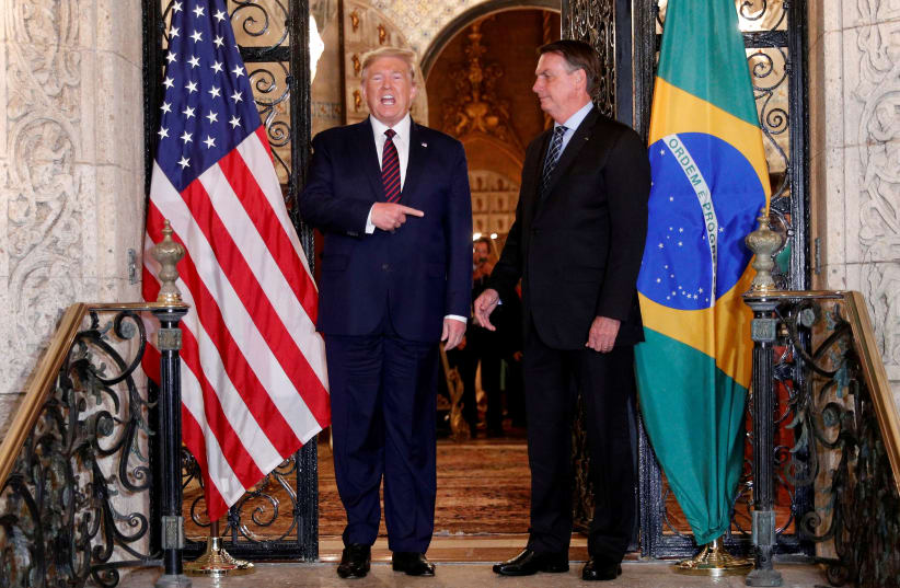 U.S. President Donald Trump hosts a photo-op with Brazilian President Jair Bolsonaro before attending a working dinner at the Mar-a-Lago resort in Palm Beach, Florida, U.S., March 7, 2020 (photo credit: REUTERS/TOM BRENNER)