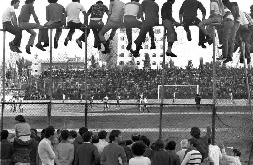 THE INNOCENCE of yesteryear Jerusalem comes through in Betar Jerusalem fans enjoying a free view of their team’s games at the old YMCA ground. (photo credit: REUVEN MILON)