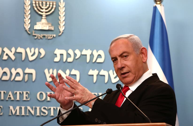 Israeli Prime Minister Benjamin Netanyahu gestures as he delivers a speech at his Jerusalem office, regarding the new measures that will be taken to fight the coronavirus, March 14, 2020 (photo credit: GALI TIBBON POOL/REUTERS)