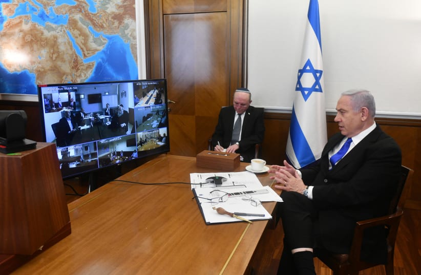 Prime Minister Benjamin Netanyahu attends the weekly cabinet meeting, held over video conference due to the novel coronavirus, March 15, 2020. (photo credit: CHAIM TZACH/GPO)