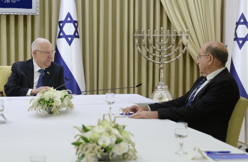 President Reuven Rivlin speaks with Blue and White MK Moshe Ya'alon about the possibility of forming an emergency unity government. (photo credit: MARK NEYMAN/GPO)