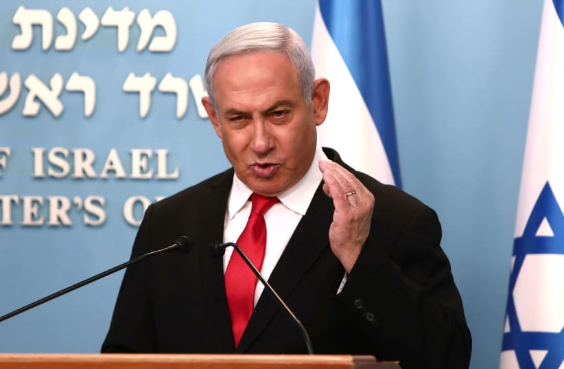 Israeli Prime Minister Benjamin Netanyahu gestures as he delivers a speech at his Jerusalem office, regarding the new measures that will be taken to fight the coronavirus, March 14, 2020 (photo credit: REUTERS/GALI TIBBON/POOL)